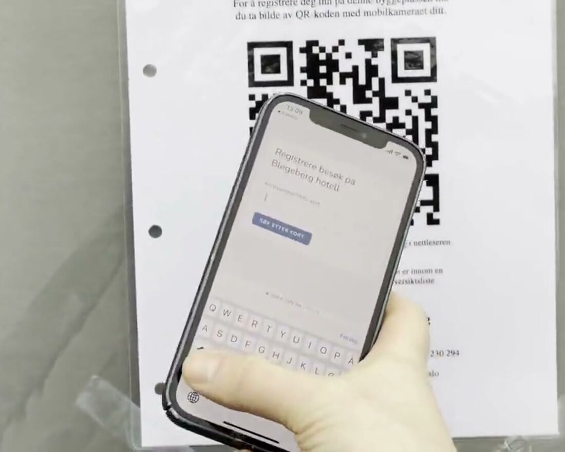 Arbeider skanner QR-koden på HMS-kortet med mobilen på byggeplassen
